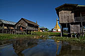 Inle Lake Myanmar. All the buildings are constructed on piles. Residents travel around by canoe, but there are also bamboo walkways and bridges over the canals, monasteries and stupas. 